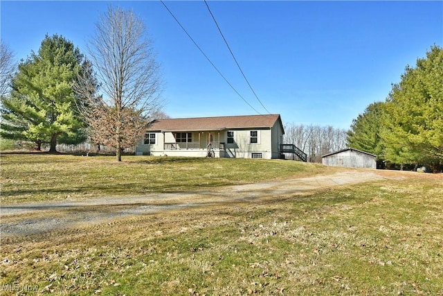 view of front of property with driveway, a porch, and a front yard