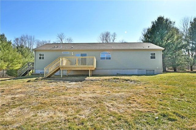 back of property featuring stairs, a deck, and a lawn