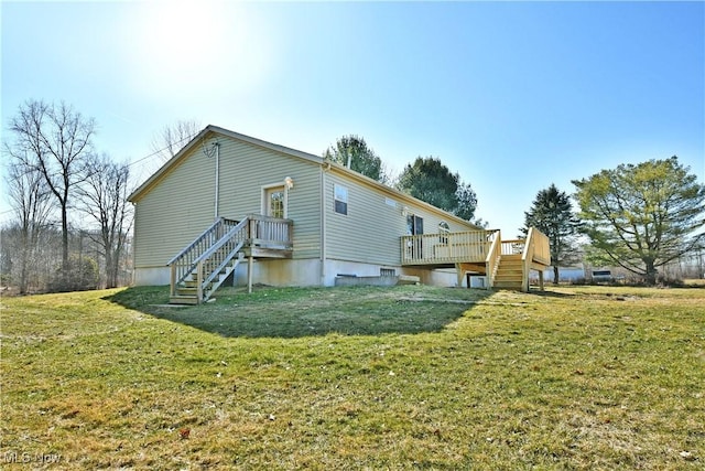 back of property with a yard and a wooden deck