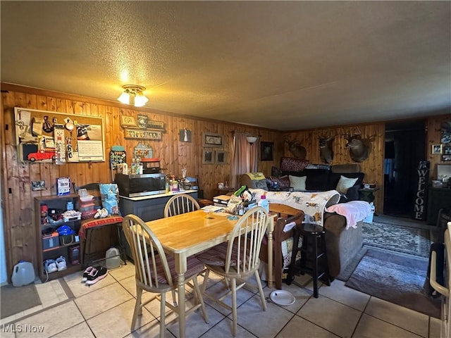 dining space with light tile patterned flooring and a textured ceiling