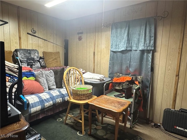 bedroom featuring carpet and wood walls