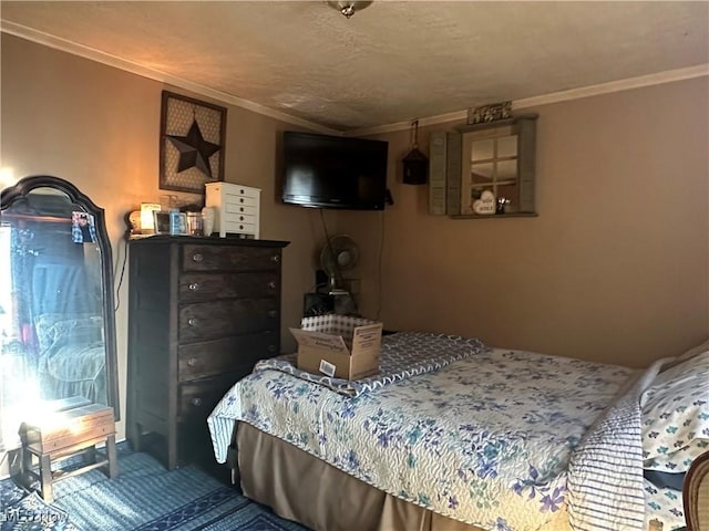 bedroom featuring a textured ceiling, carpet floors, and ornamental molding