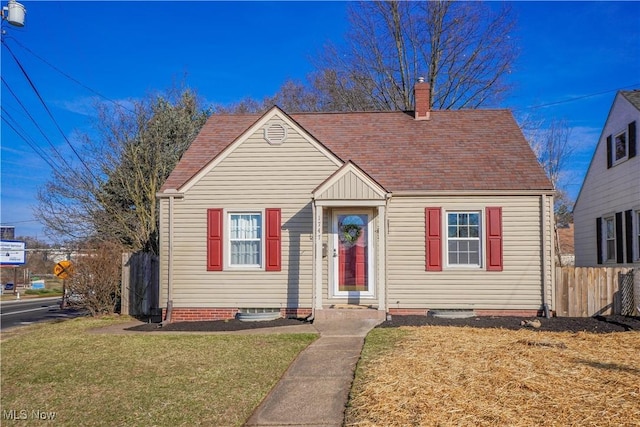 bungalow with a chimney, a front lawn, and fence