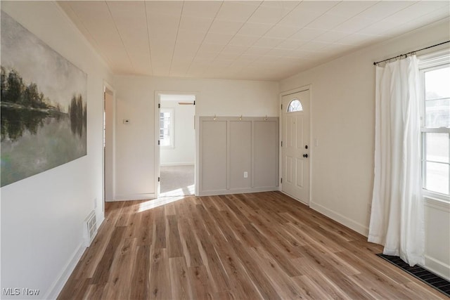 entryway with visible vents, baseboards, and wood finished floors