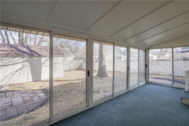 unfurnished sunroom featuring vaulted ceiling