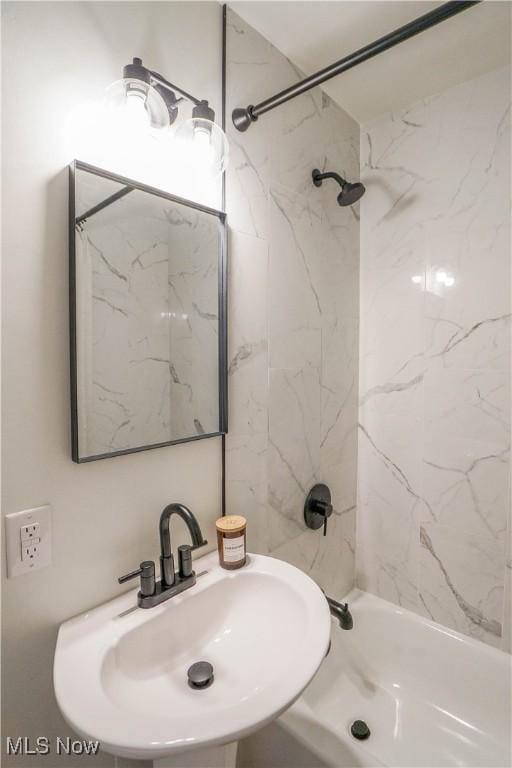 bathroom with tub / shower combination and a sink