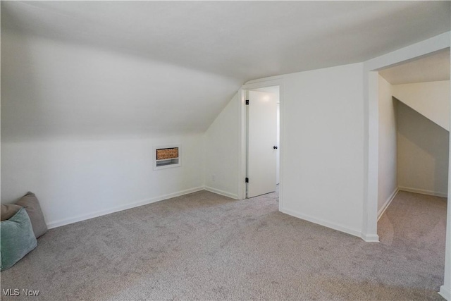 bonus room featuring baseboards, lofted ceiling, and carpet flooring