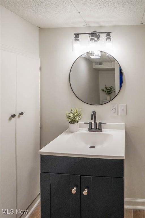 bathroom with vanity and a textured ceiling