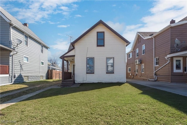 rear view of house with a yard