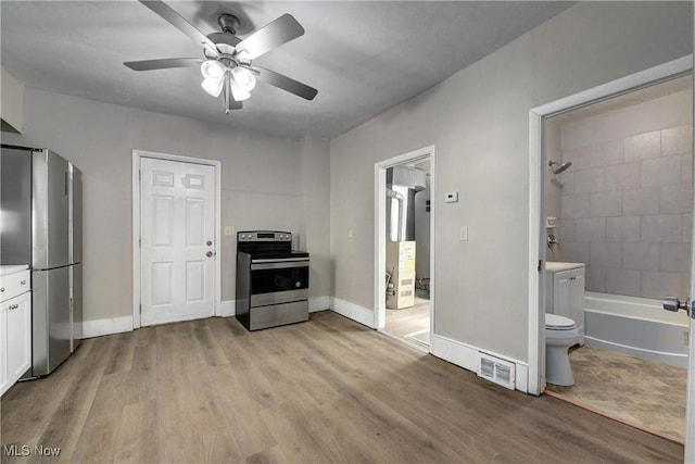 kitchen featuring visible vents, light wood-type flooring, appliances with stainless steel finishes, and white cabinetry