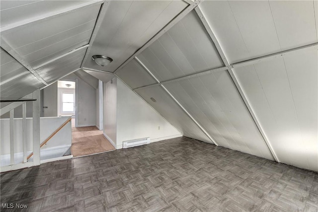 bonus room with a baseboard heating unit and lofted ceiling