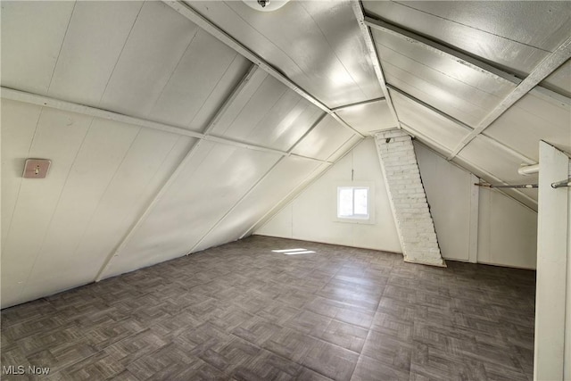 additional living space featuring lofted ceiling