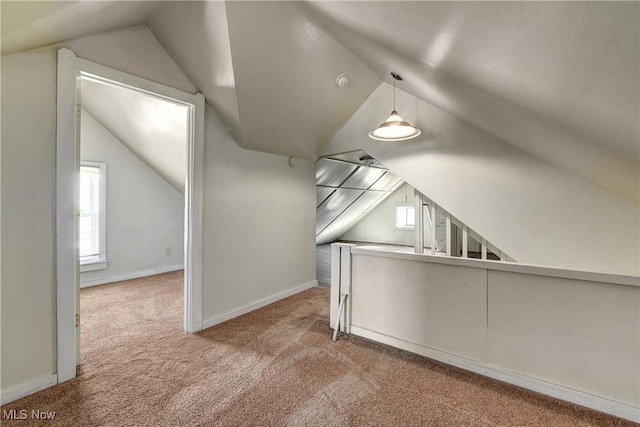 bonus room featuring vaulted ceiling, baseboards, and carpet floors