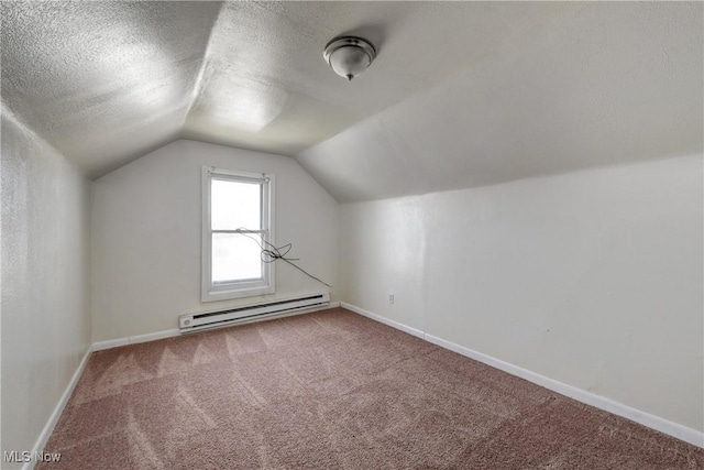 additional living space featuring baseboards, carpet floors, lofted ceiling, a textured ceiling, and a baseboard heating unit