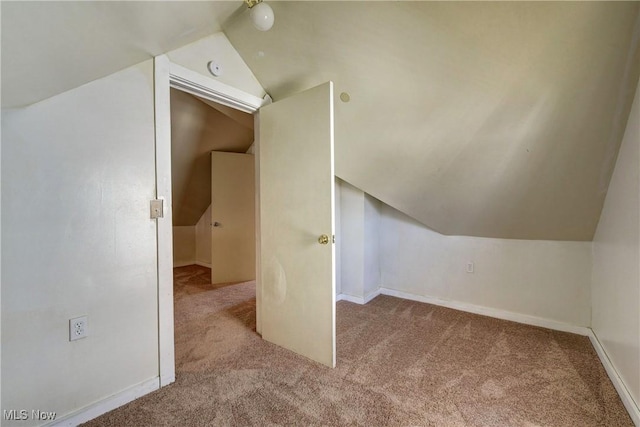 bonus room with vaulted ceiling, baseboards, and carpet floors