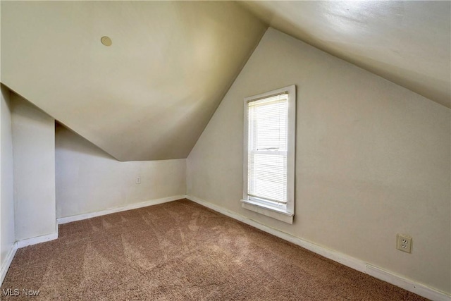 bonus room featuring lofted ceiling, baseboards, and carpet floors