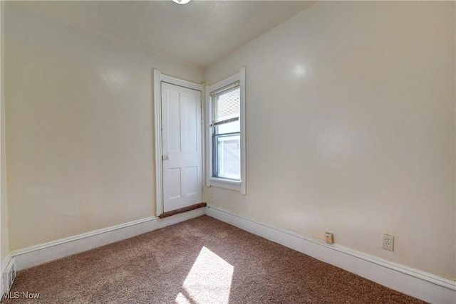 carpeted empty room with baseboards