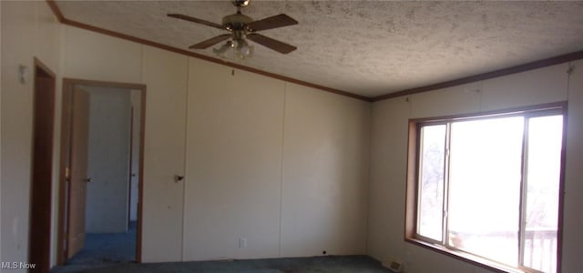 spare room featuring visible vents, a textured ceiling, ceiling fan, and crown molding