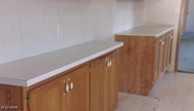 kitchen featuring brown cabinets and light countertops