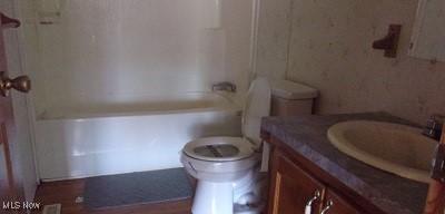 full bath featuring toilet and vanity