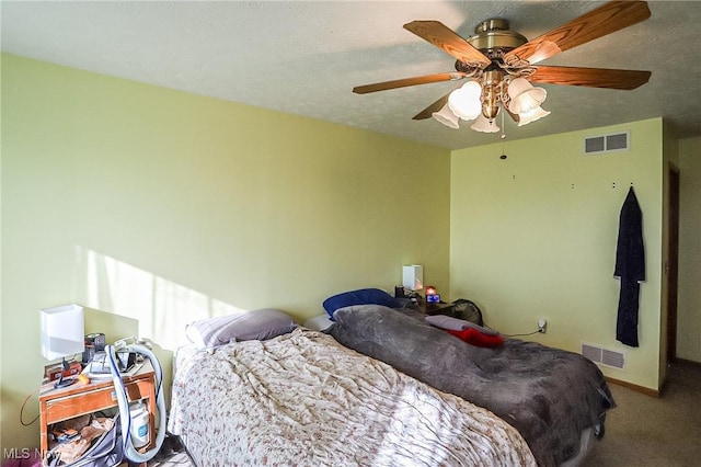 carpeted bedroom with baseboards, a ceiling fan, visible vents, and a textured ceiling