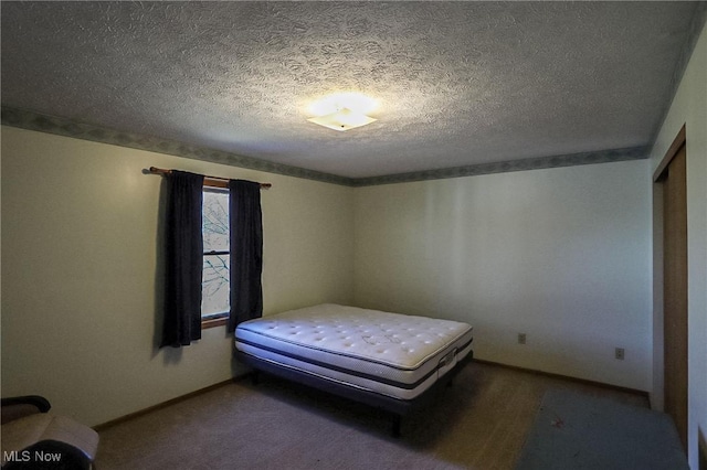 unfurnished bedroom featuring a textured ceiling and baseboards