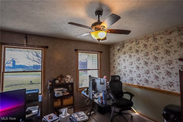 office with a ceiling fan and a textured ceiling