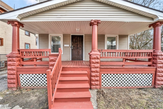 view of front of home with stairs and covered porch