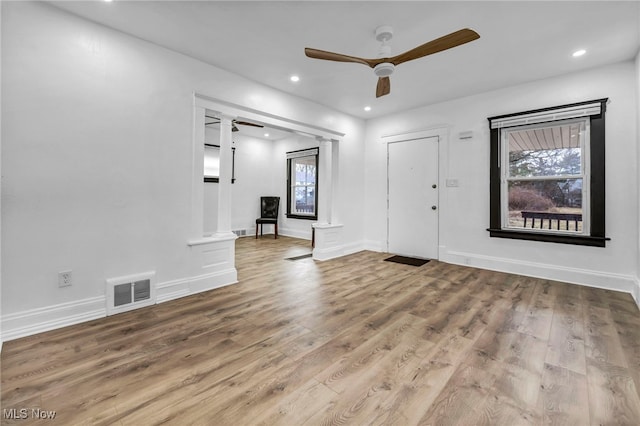 entryway with wood finished floors, a ceiling fan, visible vents, and a wealth of natural light