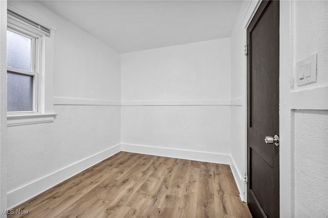 unfurnished room featuring wood finished floors and baseboards