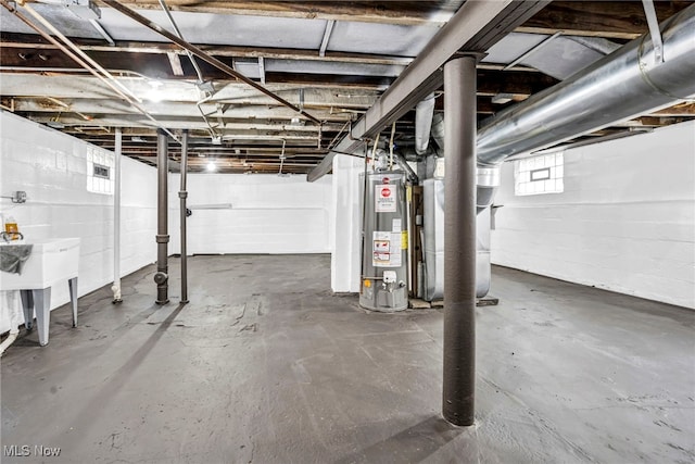 basement with a sink and water heater