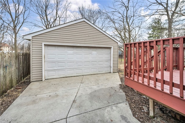 detached garage featuring fence