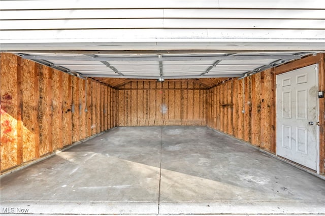 garage featuring wooden walls