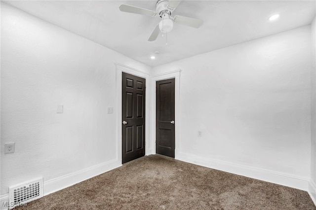 empty room featuring visible vents, recessed lighting, carpet, baseboards, and ceiling fan