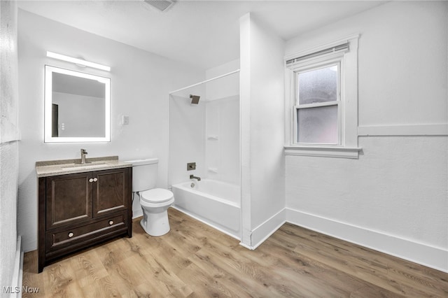 full bathroom with visible vents, tub / shower combination, toilet, wood finished floors, and vanity