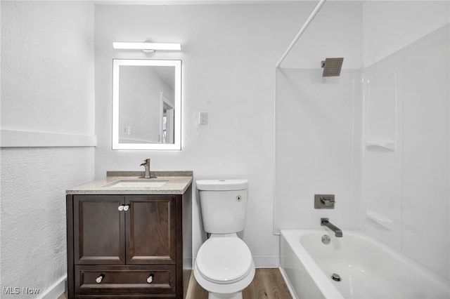 full bathroom featuring vanity, wood finished floors, baseboards, toilet, and shower / bathtub combination