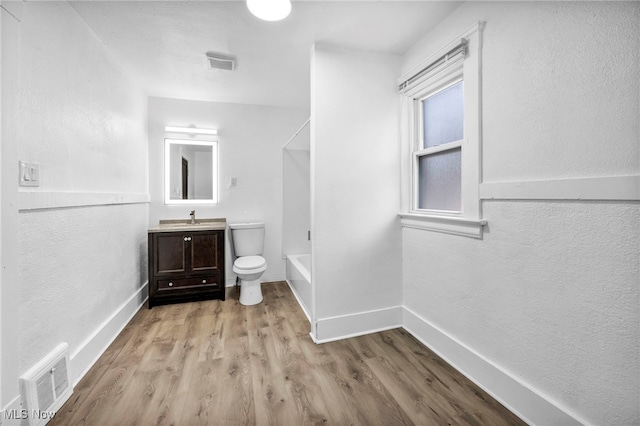 bathroom featuring visible vents, toilet, wood finished floors, and vanity