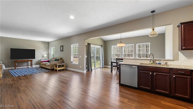 kitchen featuring dishwasher, dark wood finished floors, open floor plan, and a sink