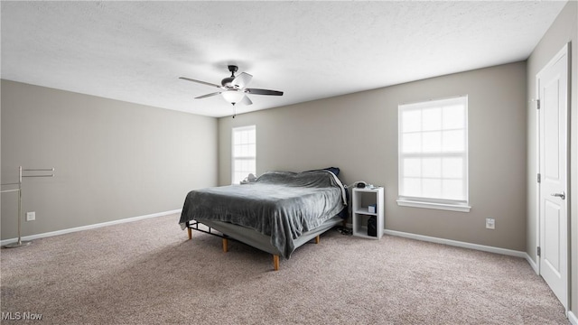 bedroom featuring a textured ceiling, baseboards, and carpet