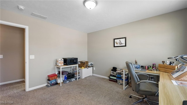 carpeted office with visible vents and baseboards