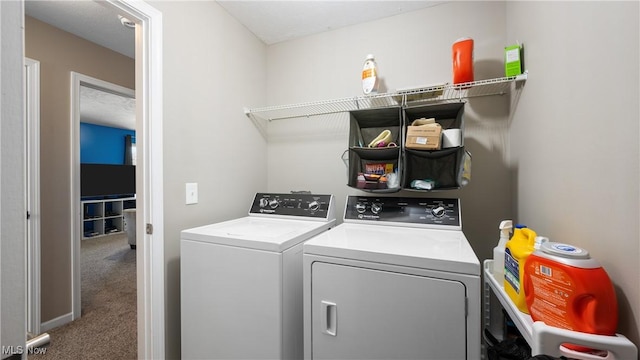 clothes washing area with laundry area, carpet floors, and separate washer and dryer