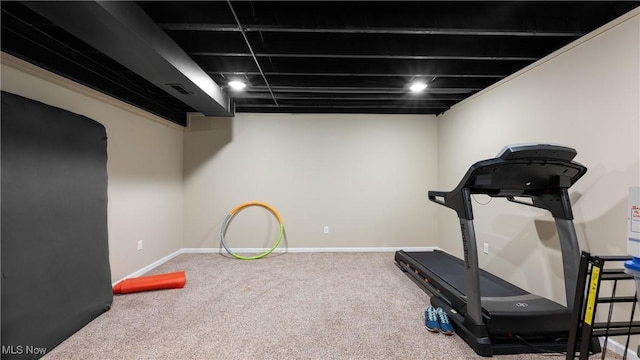 workout area with visible vents, baseboards, and carpet