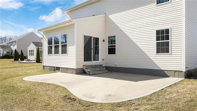 rear view of property with a patio area, a lawn, and entry steps