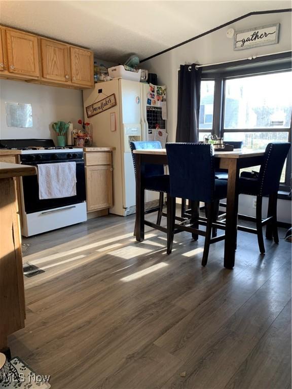 kitchen featuring dark wood finished floors, white appliances, and visible vents