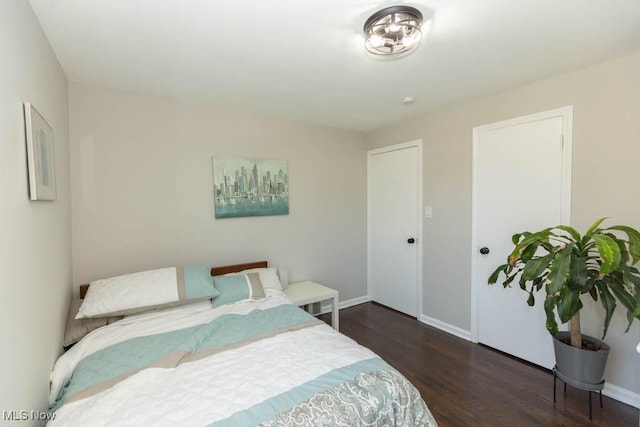 bedroom featuring baseboards and wood finished floors