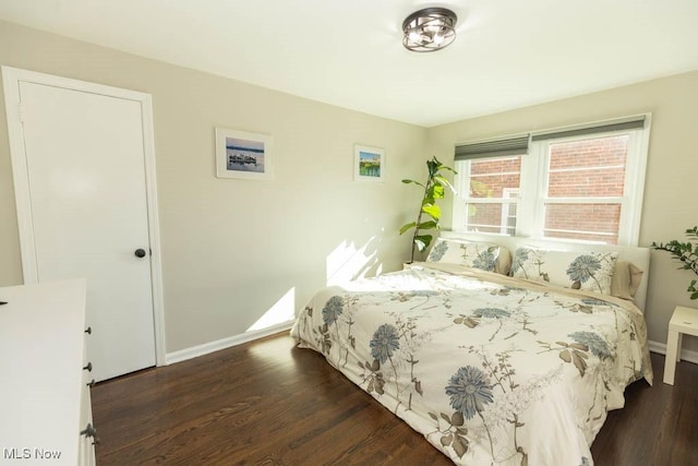 bedroom with baseboards and wood finished floors