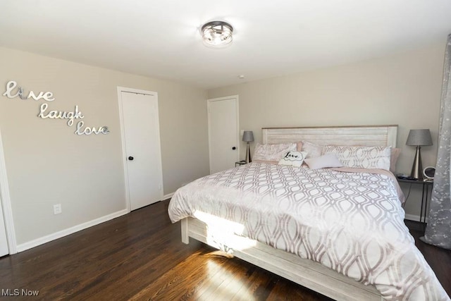 bedroom with baseboards and wood finished floors