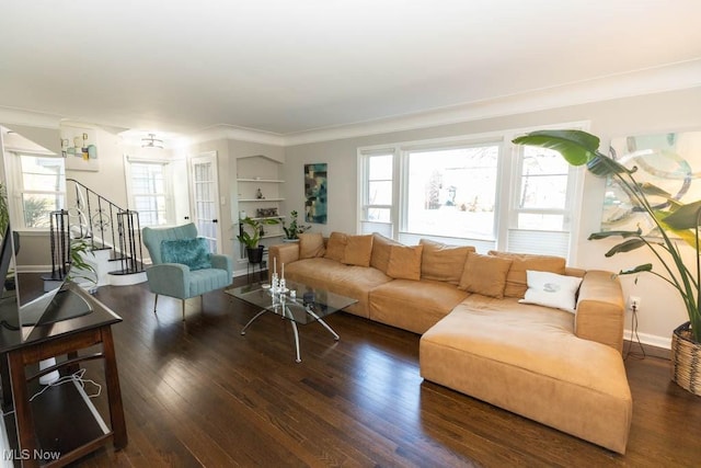 living room with a healthy amount of sunlight, stairs, baseboards, and wood finished floors