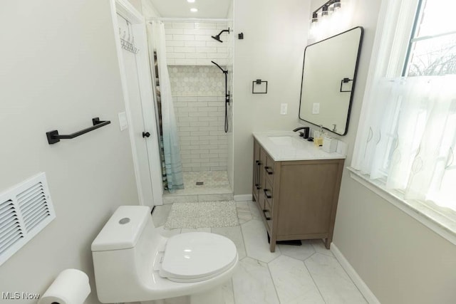 full bath with visible vents, a shower stall, baseboards, toilet, and vanity