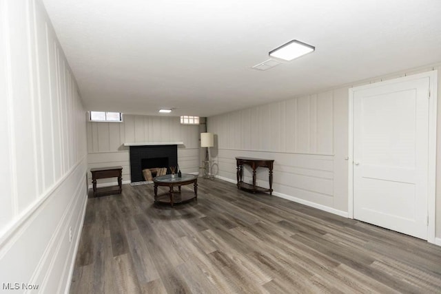 living area with wood finished floors and a fireplace